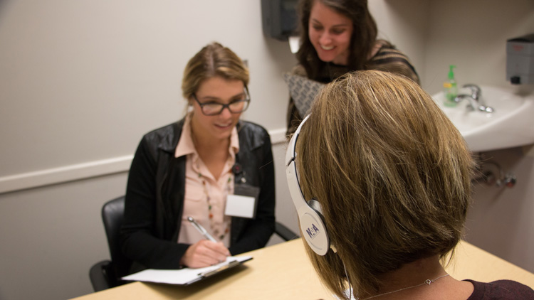 a student working with a client at the speech and hearing center