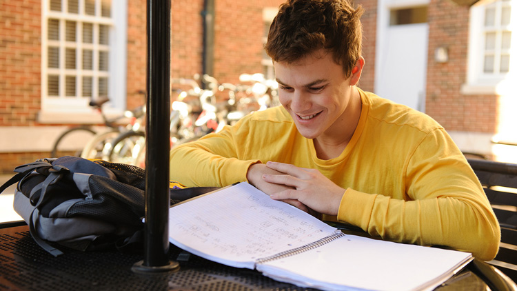 a parker-adams student studying outside